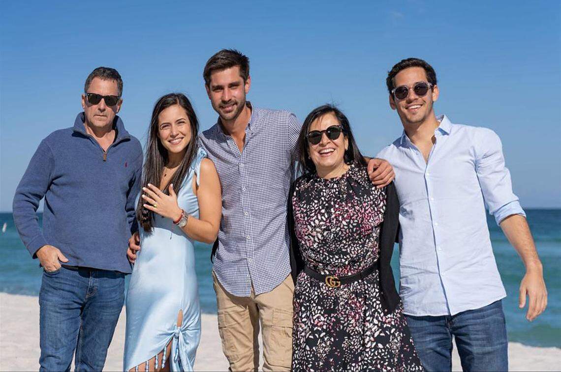 Hand Out Photo: Pablo Langesfeld, left, who lost his daughter and son-in-law in the 2021 Champlain Towers collapse, is photographed with is son, Martin Langesfeld, right, and family, now battling advanced pancreatic cancer, is suing Oscar Health Insurance for denying coverage of a drug therapy his doctors recommend, underscoring broader struggles over access to treatment. (Courtesy of Langesfeld family)