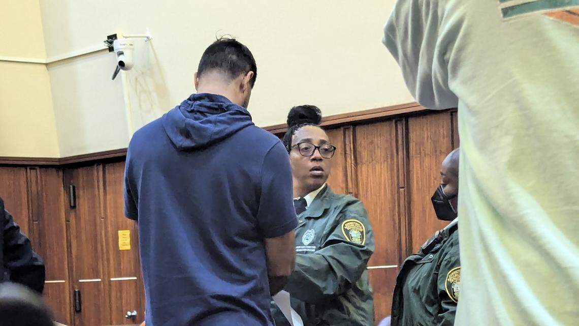 Jose Glen Rodriguez-Vazquez is taken into custody and fingerprinted after agreeing to a year in jail for his interactions with a teenage girl while he was athletics director at a charter school two years ago.