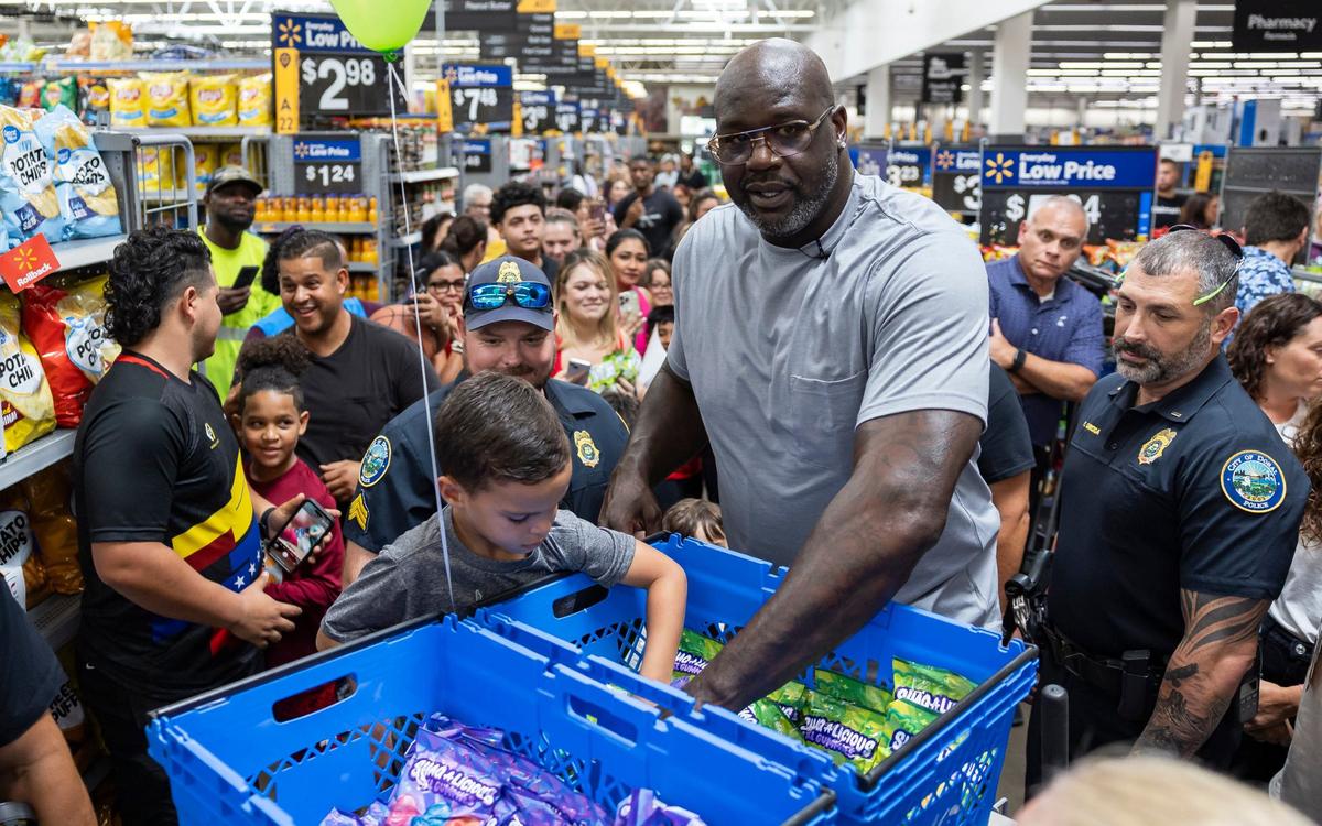 Former Miami Heat player Shaquille O’Neal gifts shoppers free bags of his newly launched Shaq-a-licious gummies at a Walmart on Monday, Aug. 12, 2024, in Doral, Fla.