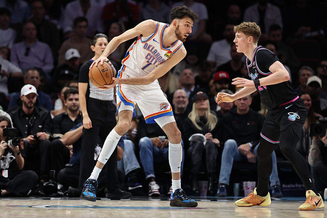 Chet Holmgren #7 of the Oklahoma City Thunder controls the ball against Kasparas Jakucionis #25 of the Miami Heat during the first half at Kaseya Center on January 17, 2026 in Miami.