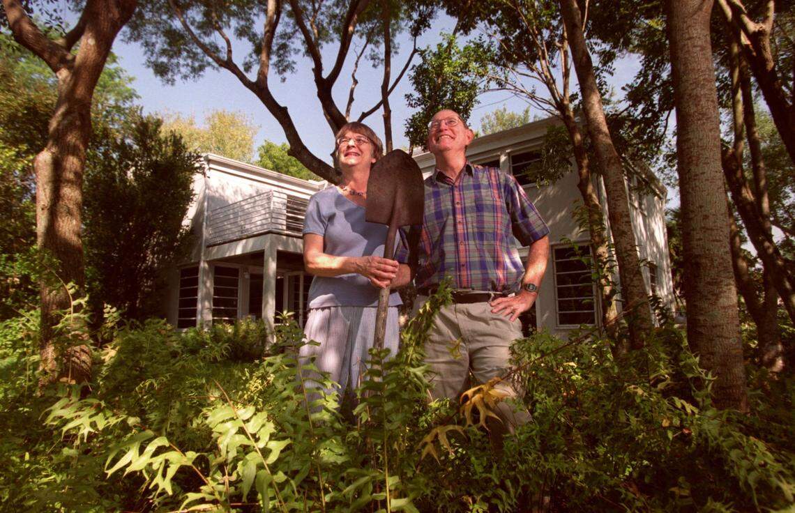 Janat, left, and Jack Parker stand in the backyard of their energy efficient home in this photo from 2001. The green area they are standing in was design to cool the southeasterly breezes before they reach the house.