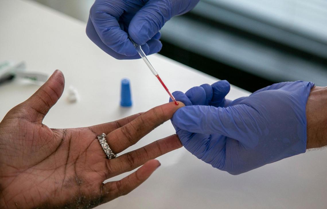 Robert Blaisdell, owner of Blue Med Consultants performs an antibody test in February on Asha Wedermier, a front office agent at SLS Brickell.