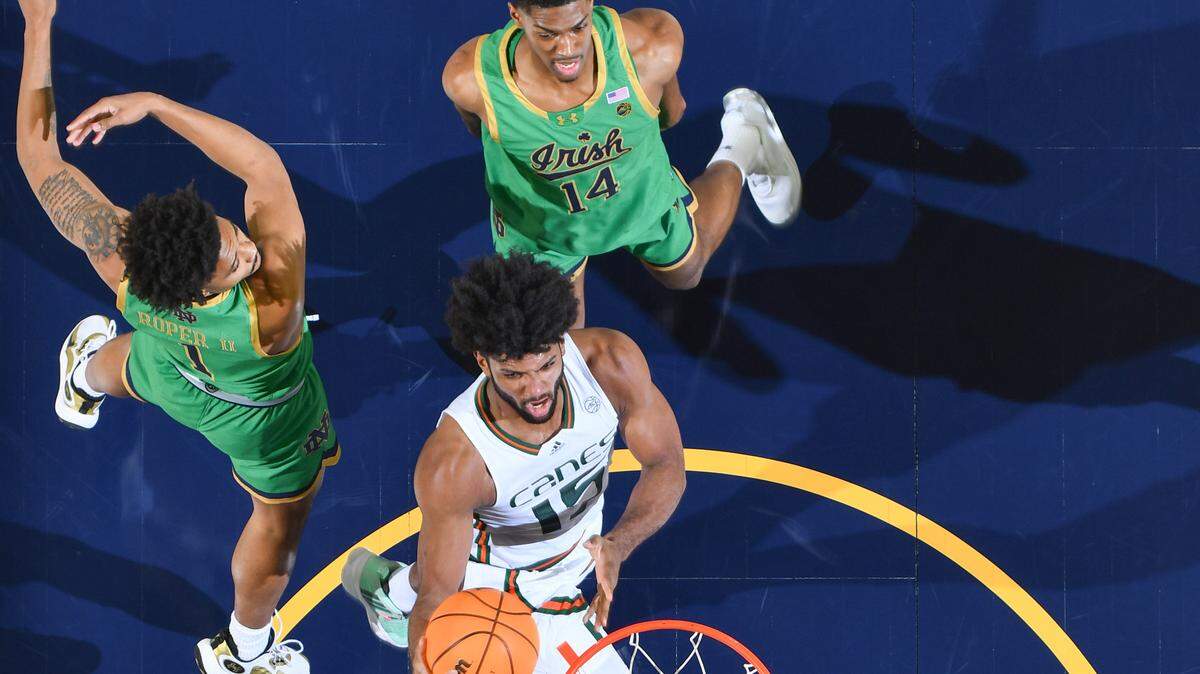 Jan 24, 2024; South Bend, Indiana, USA; Miami Hurricanes forward Norchad Omier (15) goes up for a shot as Notre Dame Fighting Irish guard Julian Roper II (1) and forward Kebba Njie (14) defend in the first half at the Purcell Pavilion. Omier finished with 33 points.