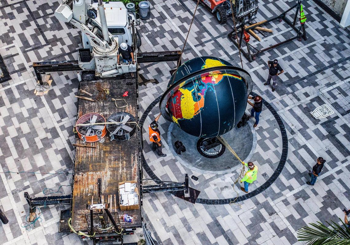 Workers install the Pan Am Globe, which used to be at the Miami science museum for 55 years until 2015 and originally sat at the Pan Am seaplane terminal in Coconut Grove, at its new location in the World Paseo and World Promenade at the Miami Worldcenter downtown. Installation of the refurbished globe took place Wednesday, July 13, 2022.