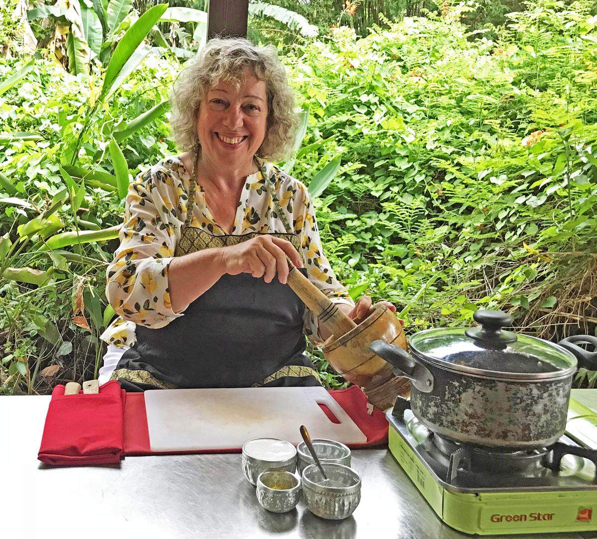 In a cooking class near Siem Reap, Marjie Lambert prepares a paste of Cambodian seasonings, to be used in making fish amok.