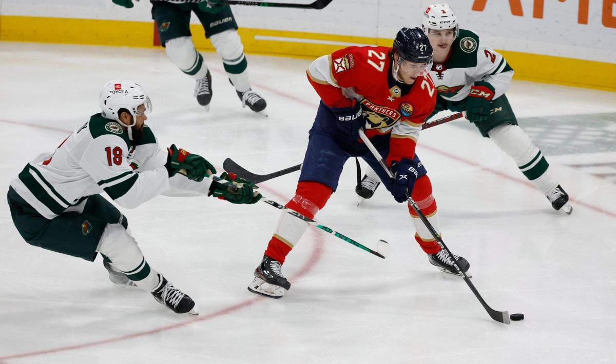Florida Panthers center Eetu Luostarinen (27) hits the puck for an unassisted score against Minnesota Wild in the second period at FLA Live Arena in Sunrise, FL on Saturday, January 21, 2023.