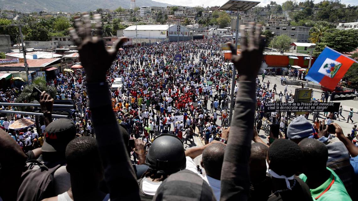 People march during a protest to demand the resignation of Haitian President Jovenel Moise in Port-au-Prince, Haiti, Sunday, Feb. 28, 2021. Opposition leaders are disputing the mandate of President Moise whose term they claim ended on Feb. 7, but the president and his supporters say his five-year term only expires in 2022.