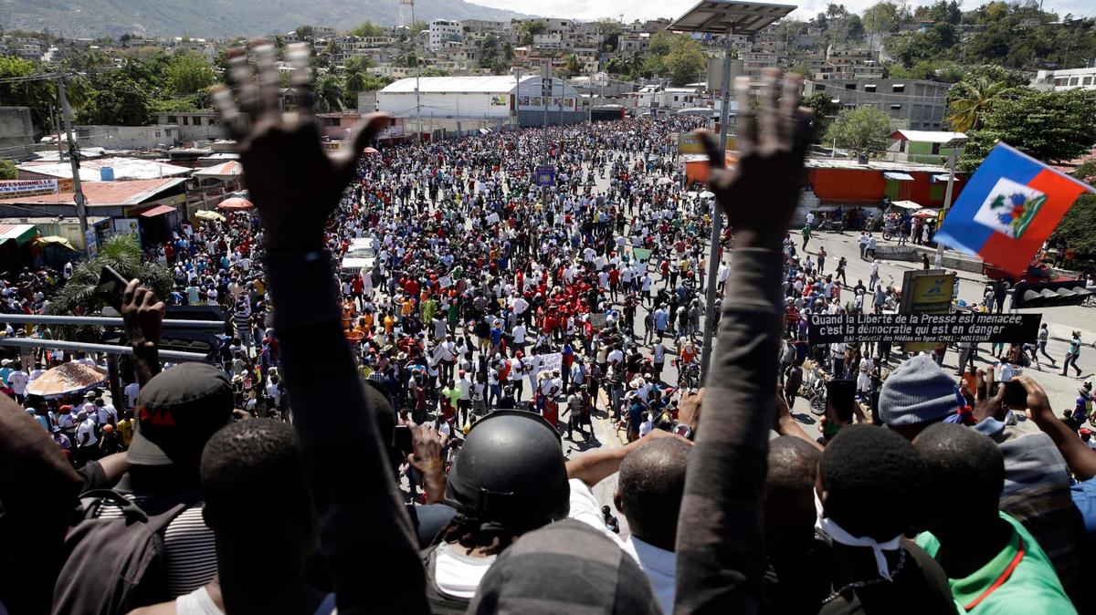 People march during a protest to demand the resignation of Haitian President Jovenel Moise in Port-au-Prince, Haiti, Sunday, Feb. 28, 2021. Opposition leaders are disputing the mandate of President Moise whose term they claim ended on Feb. 7, but the president and his supporters say his five-year term only expires in 2022.