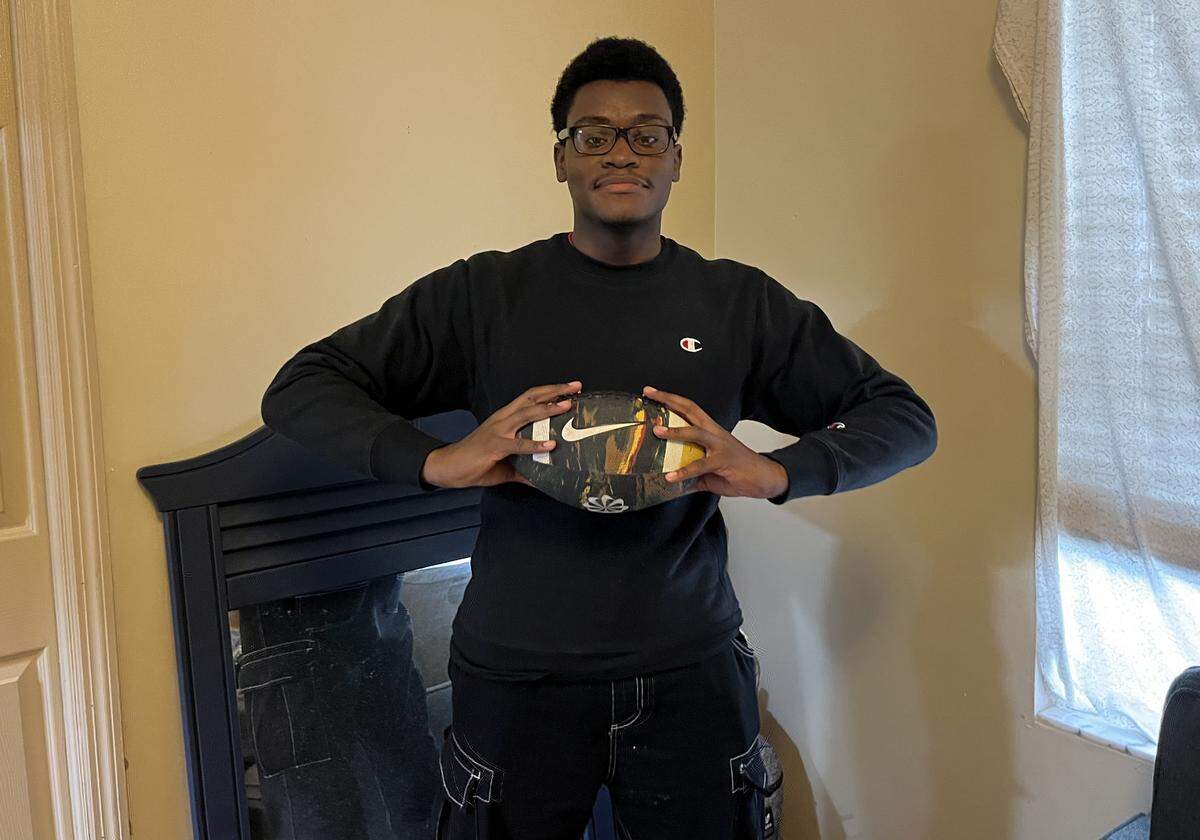 David Gaston grasps a football to symbolize his love for the NFL. His favorite team is the Detroit Lions. 