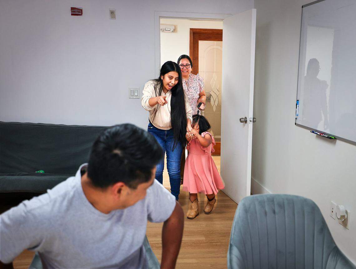 Rogelio, 39, a Guatemalan citizen who has lived in the United States since 2007 and is married to a U.S. citizen, left, turns around as Perla, leads his youngest child Daniela and wife Yolanda, right, into his attorney's office after being released by ICE on Wednesday, February 18, 2026, and arrived at his lawyer's office in Miami, Florida.