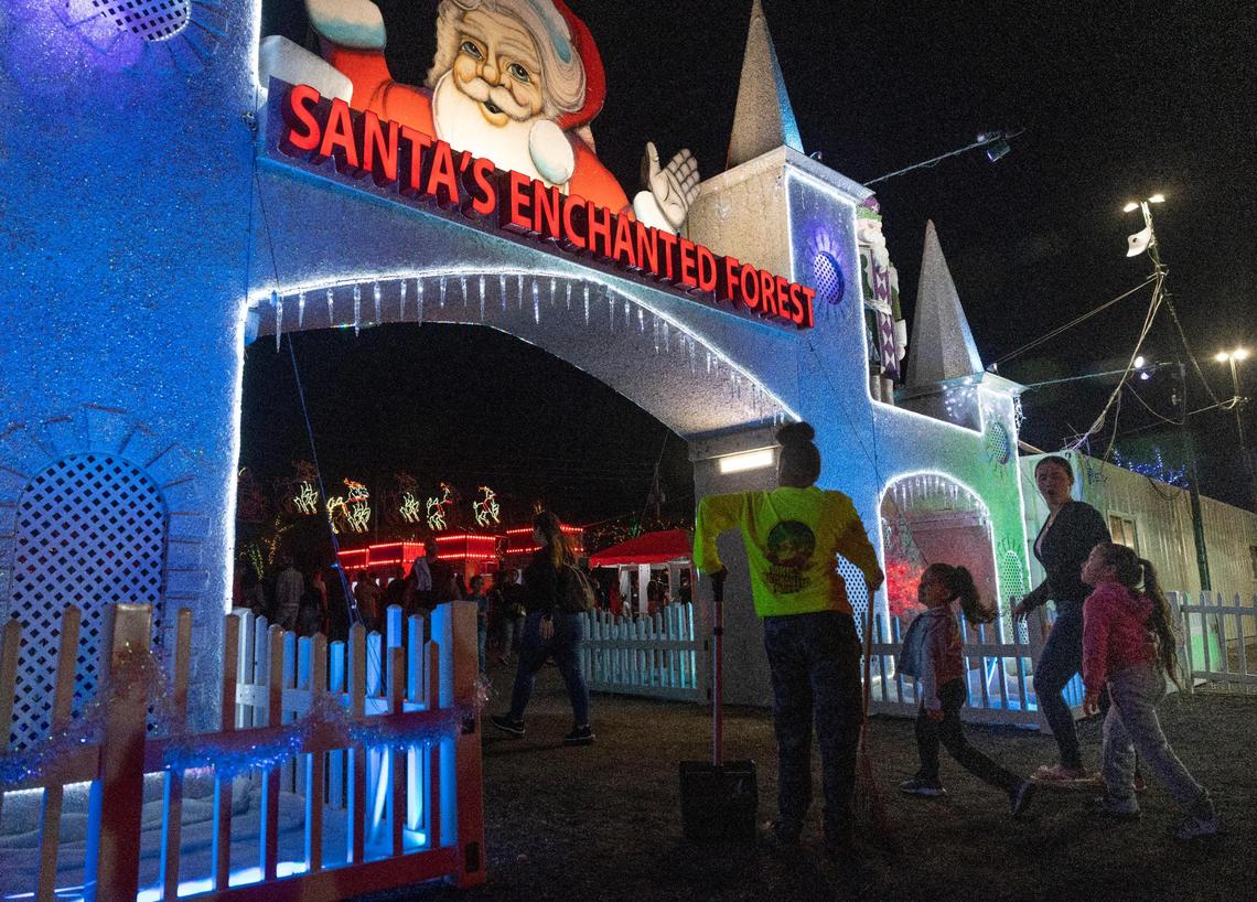 People at the iconic entrance at Santa’s Enchanted Forest, the holiday-themed amusement park that moved to Medley from Hialeah this year.