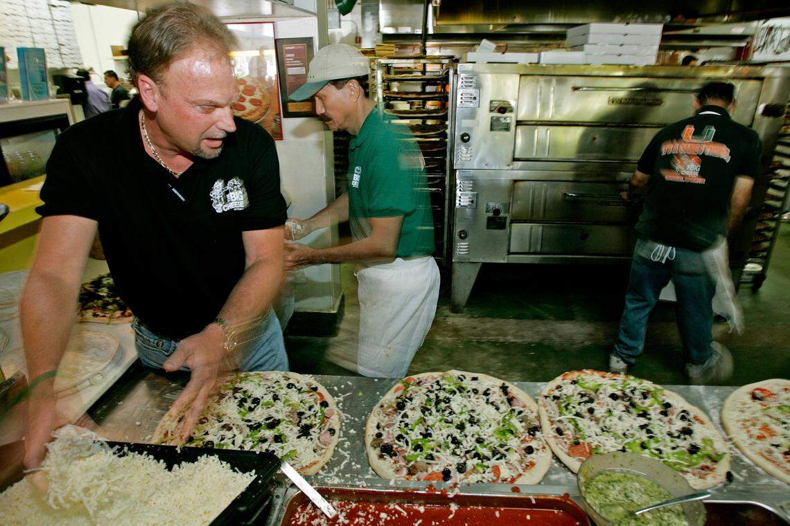 In this file photo from April 25, 2005, Bill Archer, the co-founder of The Big Cheese, spreads mozzarella cheese during pizza preparation at his restaurant, The Big Cheese in South Miami during the lunch rush hour.