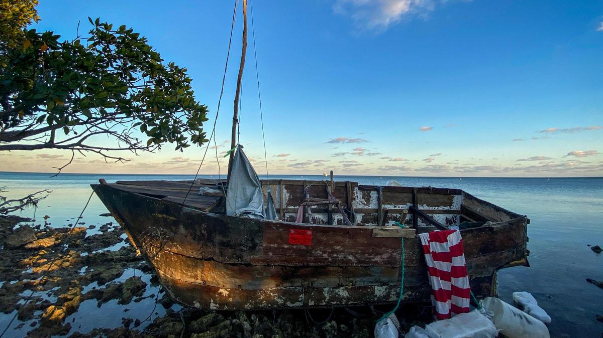 A homemade boat used by Cuban migrants to reach the United States sits off shore at Harry Harris Park in Tavernier, in the Florida Keys, on Jan. 14, 2023.