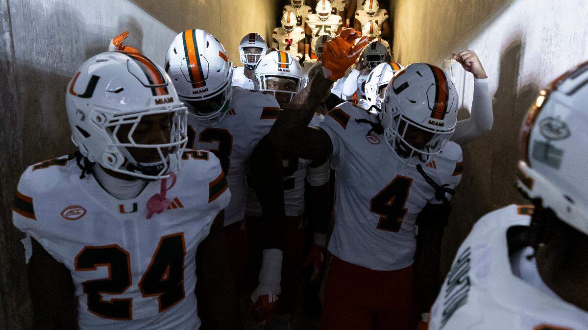 Miami Hurricanes make their way onto the field before their NCAA college football game against the California Golden Bears at the California Memorial Stadium on Saturday, Oct. 5, 2024, in Berkeley, Calif.