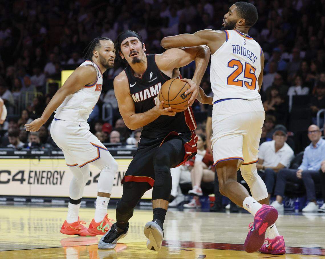 Miami Heat guard Jaime Jaquez Jr. (11) battles New York Knicks guard/forward Mikal Bridges (25) during the first half of their NBA basketball game at Kaseya Center in Miami on October 26, 2025.