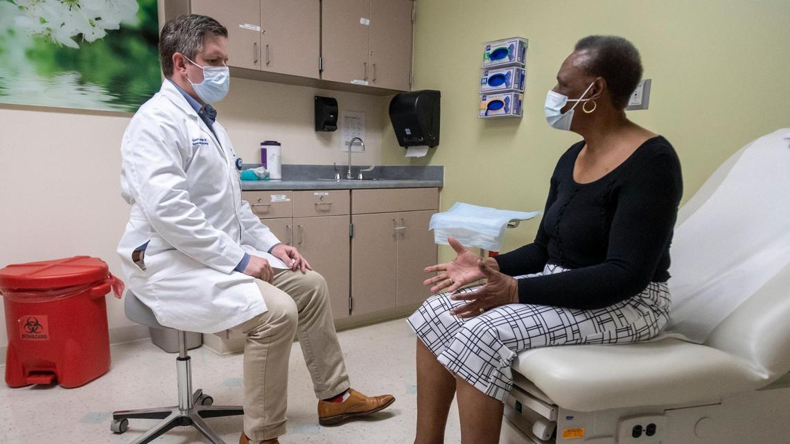Fort Lauderdale, May 11, 2022 - Dr. Scott Jordan, left, a gynecological oncologist at Broward Health Medical Center, listens to Ernestine Turner during a visit. She was diagnosed with cervical cancer when she was 72. Black woman have a higher risk of a late-stage diagnosis, leading to high mortality rates, compared with white women.