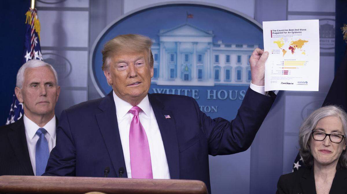 President Trump speaks at a news conference with members of the coronavirus task force. He appointed Vice President Pence, left in charge of the response to the health threat.