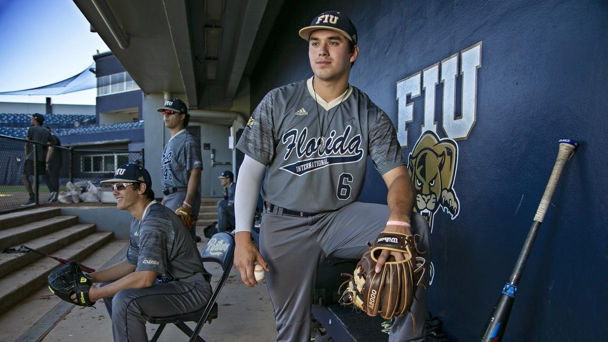 FIU third baseman Austin Shenton looks on from the dugout during practice on Thursday, Feb. 7, 2019.