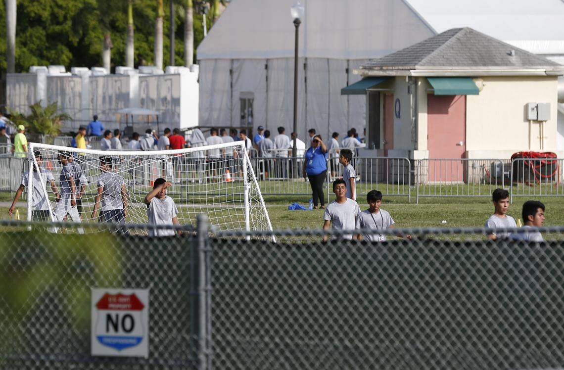 Hemmed in by fencing, migrant children play outside a former Job Corps center hat now houses them, on Monday, June 18, 2018, in Homestead, Fla. The shelter has drawn more attention of late after it was revealed that children separated from their parents at the U.S-Mexico border were ending up there.