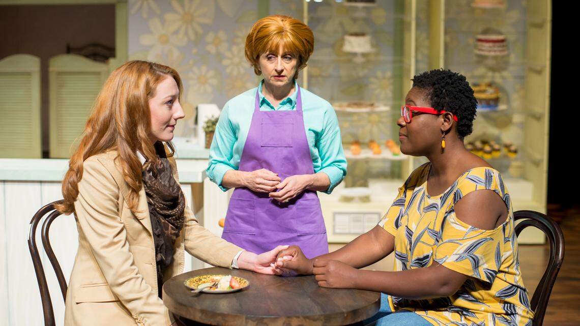 Irene Adjan as Della, center, takes in the unexpected news of wedding plans between Lexi Langs’ Jen, left, and Stephon Duncan’s Macy in City Theatre’s “The Cake.”
