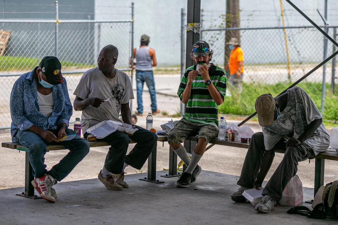 People gather to eat a meal from Homestead Soup Kitchen in Homestead, Florida on Friday, June 26, 2020.