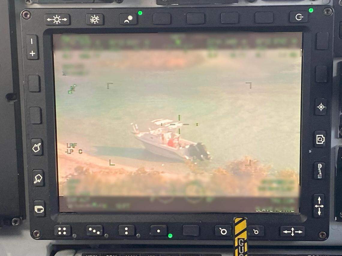 A video screen in the cockpit of a U.S. Coast Guard C-144 Ocean Sentry shows a cabin cruiser anchored feet from the shore of Cay Sal Bank in the Bahamas Saturday, Jan. 14, 2023.