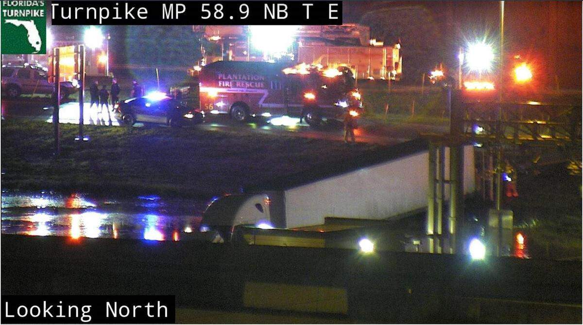 A father and son were rescued from a partially submerged 18-wheeler in a retention pond near Florida’s Turnpike in Plantation Thursday morning, according to Plantation Fire Rescue.