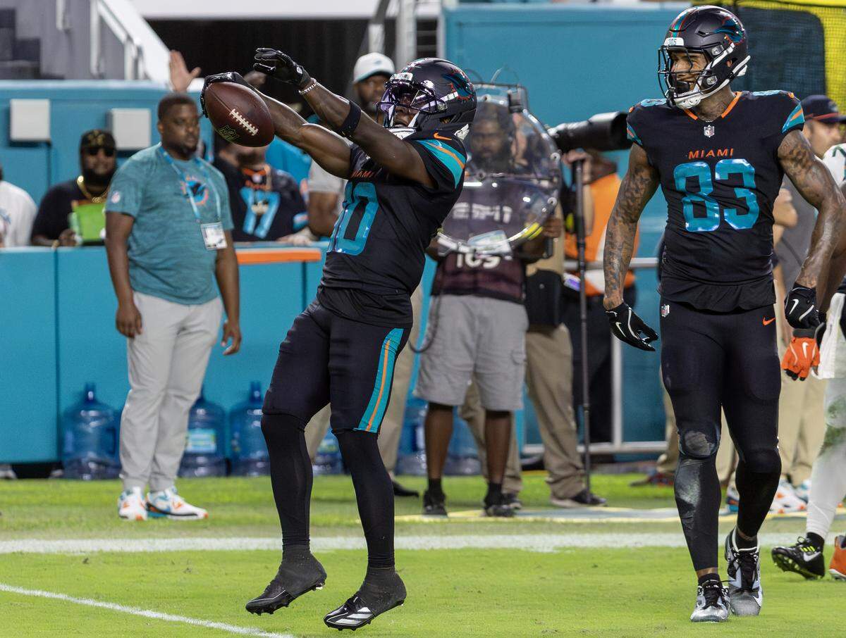 Miami Dolphins wide receiver Tyreek Hill (10) celebrates with tight end Darren Waller (83) after a first down during the first half of an NFL game against the New York Jets at Hard Rock Stadium on Monday, Sept. 29, 2025, in Miami Gardens, Fla.