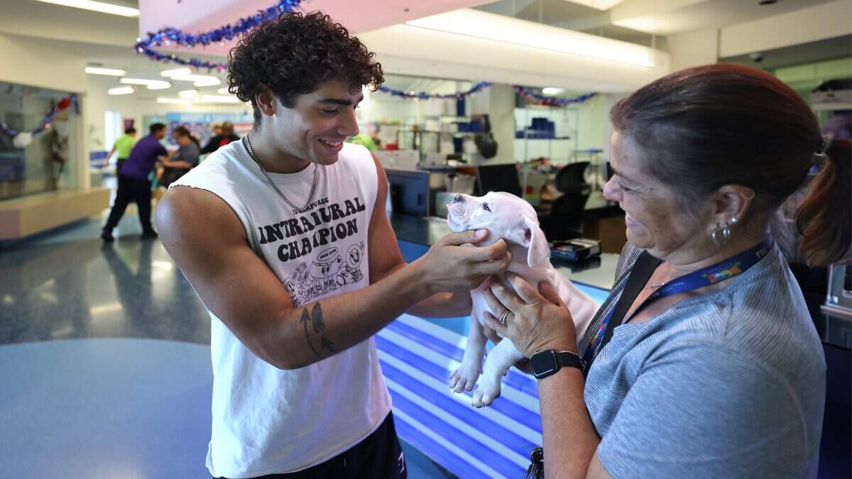 Jacob, 19, left, and his mother Raquel Garcia, are fostering “Riley” during a visit as Miami-Dade County plans to open a new animal shelter in South Dade to supplement services at its main facility in Doral, shown during a recent tour on Wednesday, July 8, 2026, in Doral, Fla.