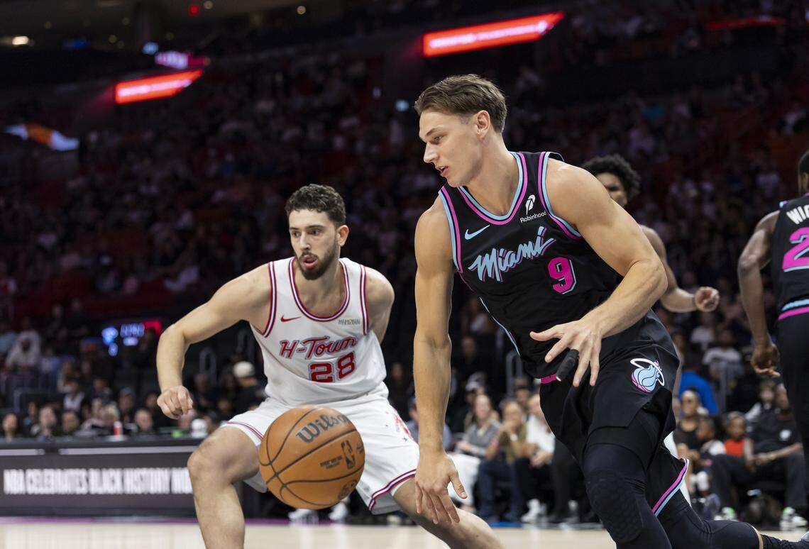 Miami Heat guard Pelle Larsson (9) drives the ball as Houston Rockets center Alperen Sengun (28) defends in the first half of their NBA game at Kaseya Center on Feb. 28, 2026, in Miami.