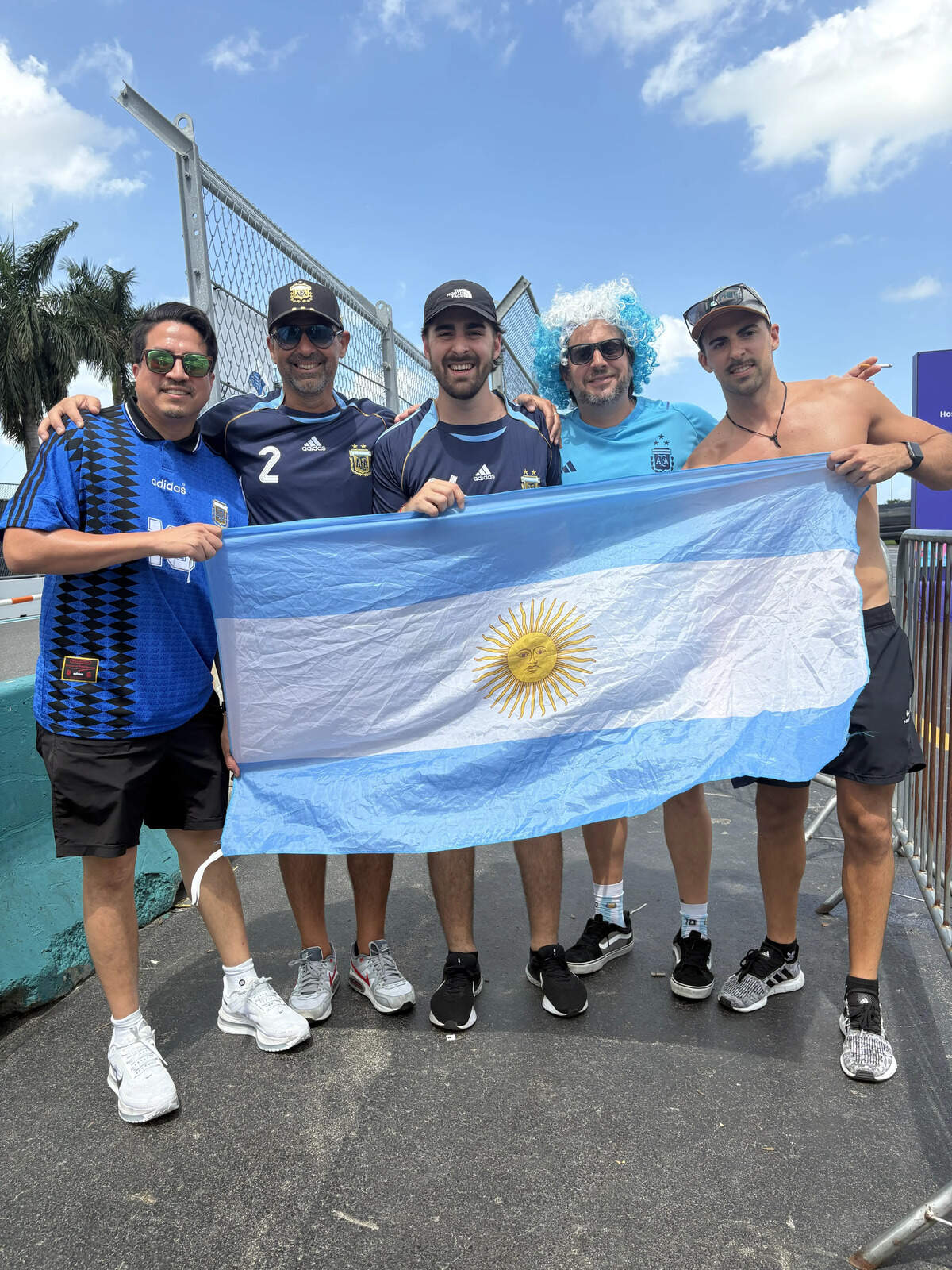 From left to right: Ezra García, Mariano Matti, Gonzalo Matti, Pedro Más, and Alejo Matti pause with the flag of Argentina outside Hard Rock Stadium on Friday, July 2, 2026.