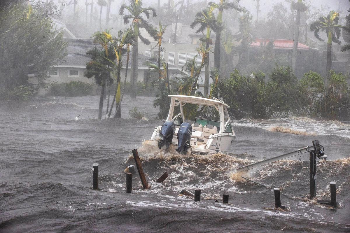 A boat is seen from the Midpoint Bridge in the Caloosahatchee River in Fort Myers as Hurricane Ian hits the west coast of Florida as a Category 4 storm on Wednesday, Sept. 28, 2022.