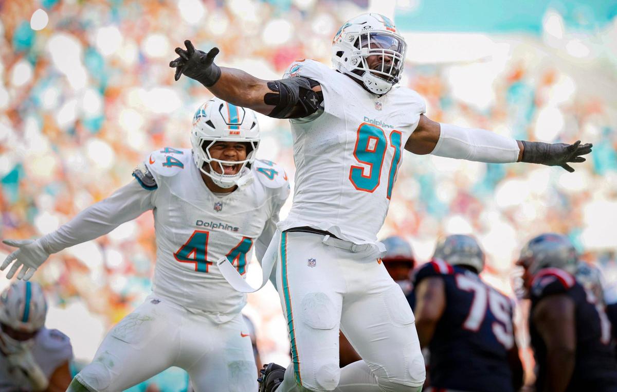 Miami Dolphins linebacker Chop Robinson (44) and linebacker Emmanuel Ogbah (91) react after sacking New England Patriots quarterback Drake Maye (10) in the first half during their NFL football game at Hard Rock Stadium in Miami Gardens, Florida, on Sunday, November 24, 2024.
