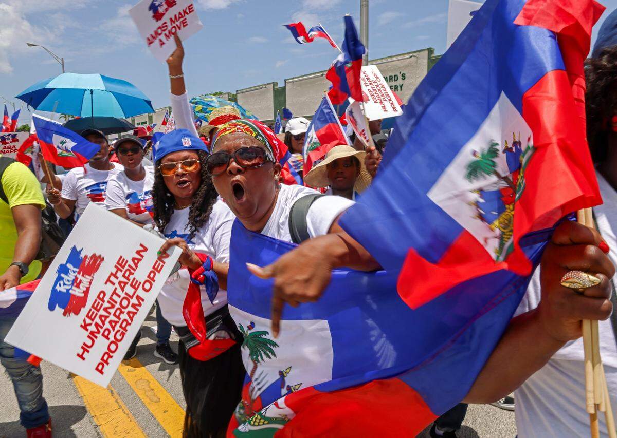 Marchers wave flags and chant words of support as members of the South Florida Haitian community joined Haitians across the U.S. and the world while marching on Sunday, July 9, 2023 to demand relief for Haiti.
