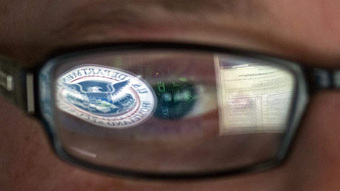 This Sept. 30, 2011, file photo shows a reflection of the Department of Homeland Security logo in the eyeglasses of a cybersecurity analyst. A new study by Tel Aviv-based cloud security company, Coronet, ranked airports across the United States to analyze their cybersecurity risk for travelers who use Wi-Fi and apps.