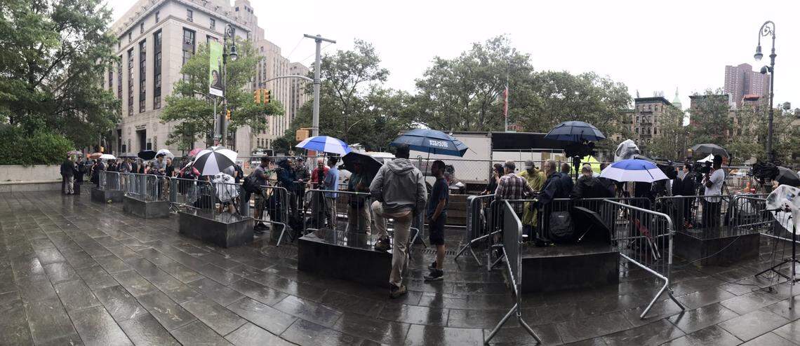 Members of the media are lined up in the rain outside the federal courthouse in Manhattan where Jeffrey Epstein was being arraigned on Monday, July 8, 2019.