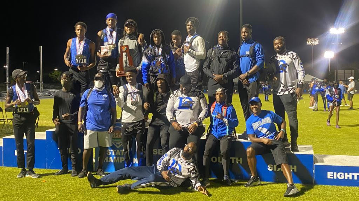 Dillard track and field athletes and coaches celebrate their first state championship on Friday after winning the Class 3A meet in Jacksonville.