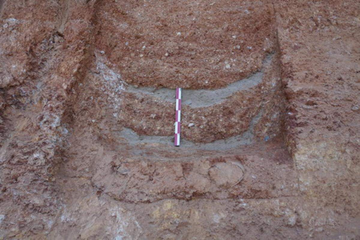 A tomb with a layer of sand in it.