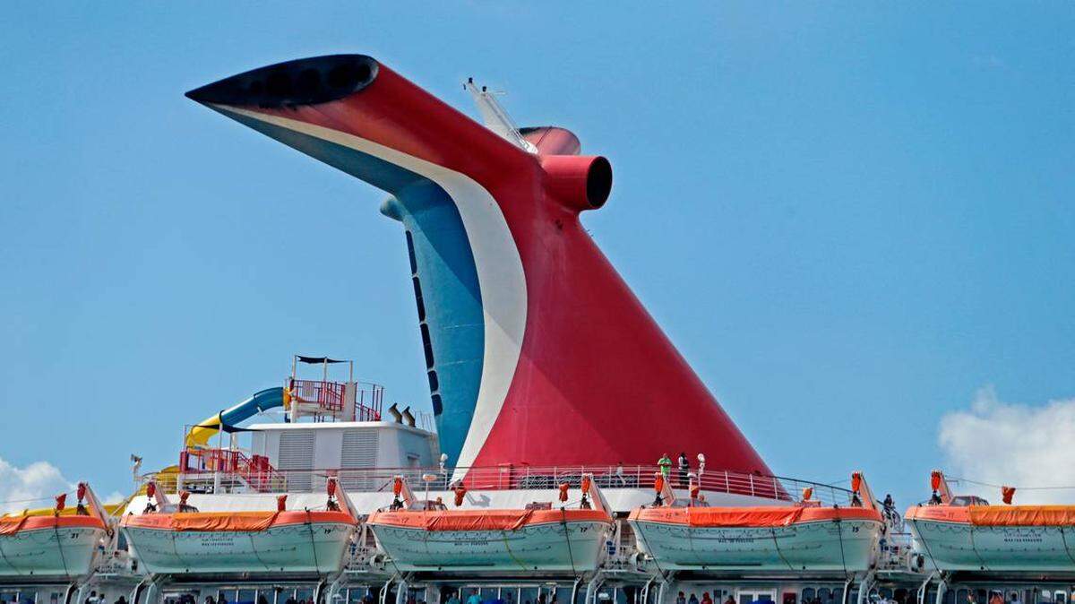 Carnival Fascination passengers look out from their balconies at PortMiami amid the COVID-19 pandemic on Tuesday, March 17, 2020.