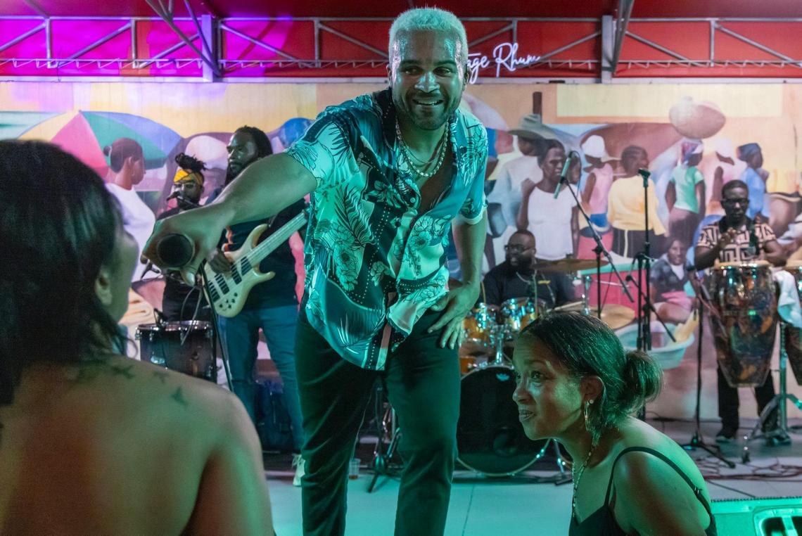 Haitian konpa star Richard Cave extends his microphone to a fan as he performs with his band KAI and delivers another electrifying performance on Friday, June 20, 2025, at “Sounds of Little Haiti” in Miami, Florida.
