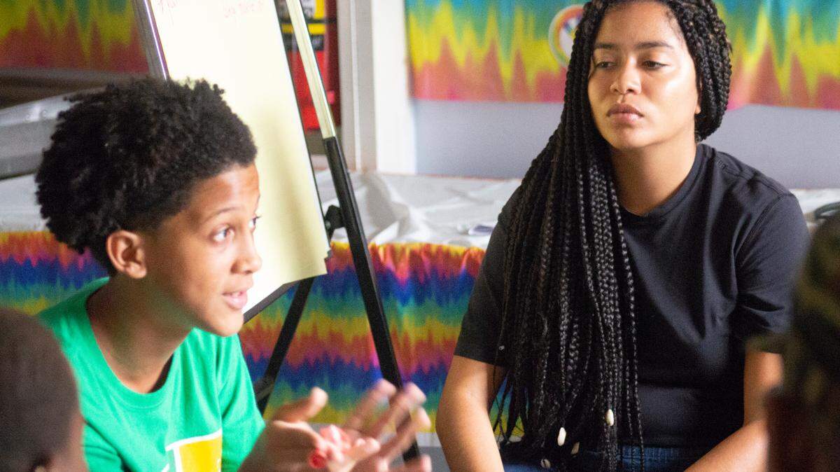 Matthew De La Cruz, a student at Miami Edison Senior High School, and Niki Franco, Power U Civic Engagement Organizer, learn together at a workshop held before the pandemic forced the group to work remotely.