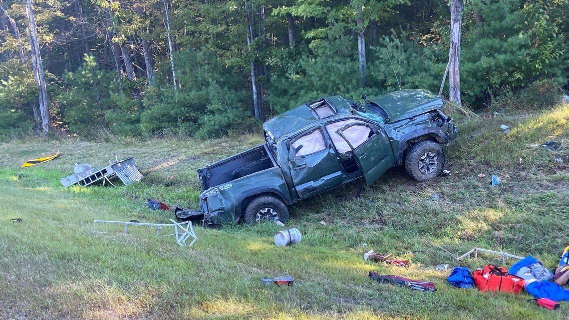 Ten dogs were thrown from pickup truck after a driver fell asleep at the wheel on a turnpike in Maine, authorities say. One dog died and another is missing.