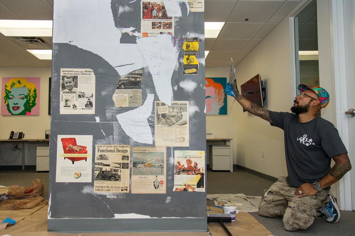 Street artist Alan Ket works on an art piece around a column inside the office of financial wealth management advisor Miguel Sosa, a founding partner of Premia Global Advisors, in Coral Gables, Sunday, June 24, 2018. Each side of the column represents an era starting with the early 1920s until present days. “It’s like a time machine,” Ket said.