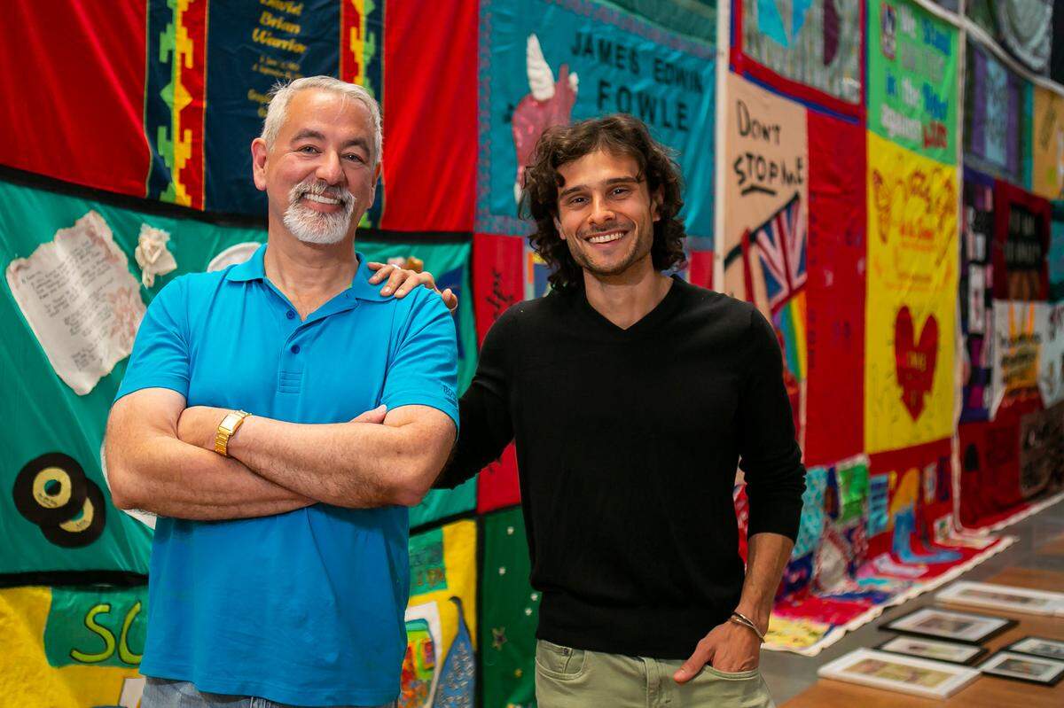 Chief Curator Shed Boren, left, and Huston Ochoa prepare for the opening of BorenÕs exhibit, A Matter of Time: Examining Forty Years of AIDS While Living through a Pandemic, at the Coral Gables Museum in Miami, Florida on Monday, April 5, 2021.