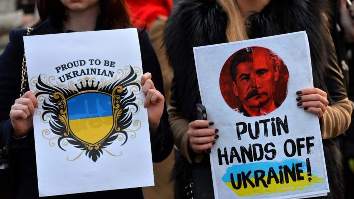 Protesters hold placards during a demonstration against Russia’s involvement in the crisis in Ukraine in London’s Parliament Square in 2014.