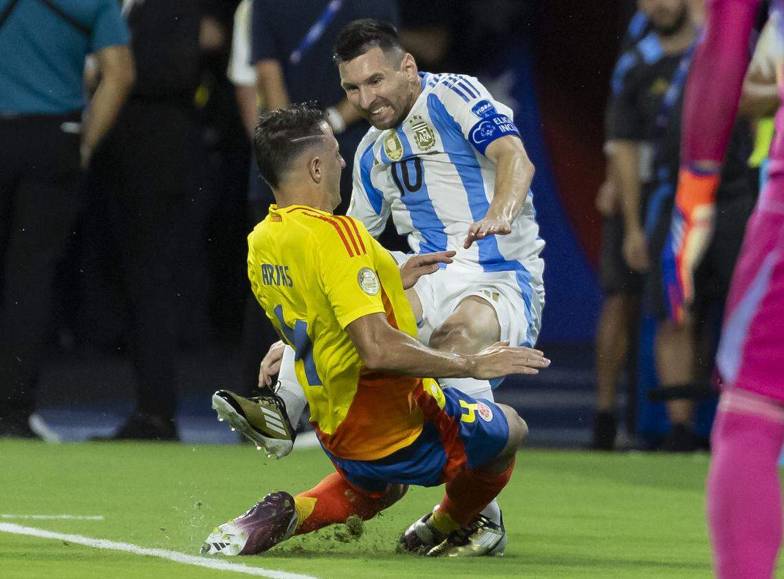 Argentina forward Lionel Messi (10) hurts his foot on a play against Colombia in the first half of their Copa America 2024 Final soccer match at Hard Rock Stadium on Sunday, July 14, 2024, in Miami Gardens, Fla.
