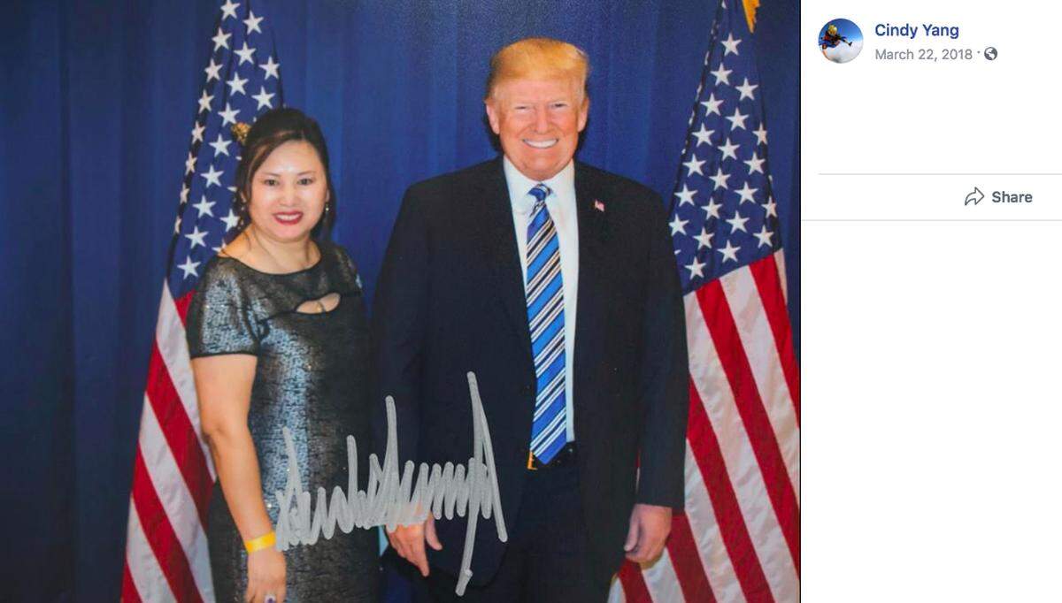Cindy Yang poses with President Donald Trump at a fundraiser at Mar-a-Lago on March 2, 2018. She received a signed photograph. A flier for the event advertised a “reception, photo and two seats for a dinner with President Trump” for a donation of $50,000.