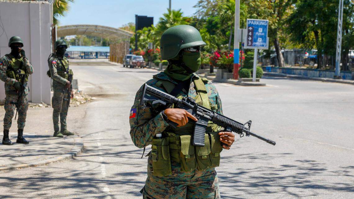 Soldiers guard the entrance of the international airport in Port-au-Prince, Haiti, Monday, March 4, 2024. Authorities ordered a 72-hour state of emergency starting Sunday night following violence in which armed gang members overran the two biggest prisons and freed thousands of inmates over the weekend. (AP Photo/Odelyn Joseph)