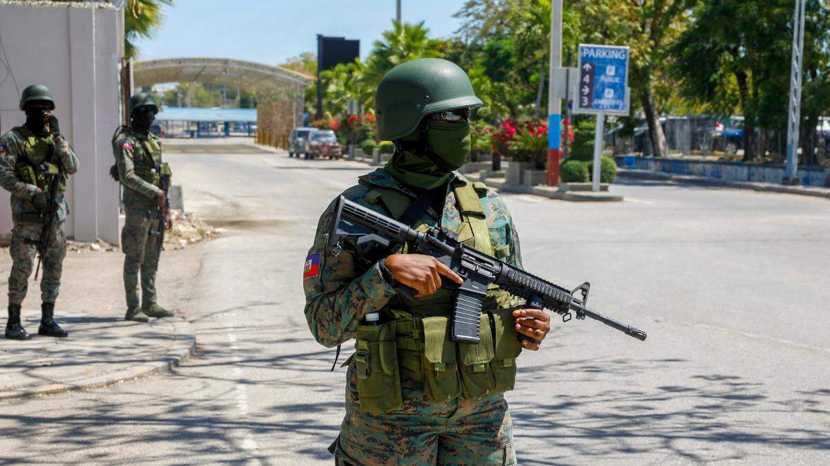 Soldiers guard the entrance of the international airport in Port-au-Prince, Haiti, Monday, March 4, 2024. Authorities ordered a 72-hour state of emergency starting Sunday night following violence in which armed gang members overran the two biggest prisons and freed thousands of inmates over the weekend. (AP Photo/Odelyn Joseph)
