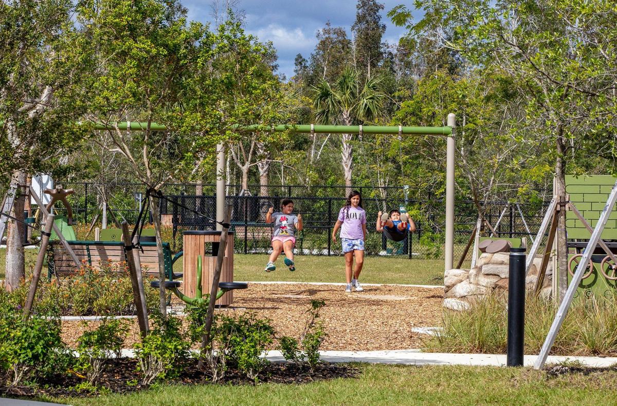 Kids enjoy the playground at west Miami-Dade’s new Tree Island Park amid native trees and plantings. The 113-acre county park in the middle of dense suburban sprawl contains an extensive remnant of restored Everglades prairie and tree islands, or hardwood hammocks.